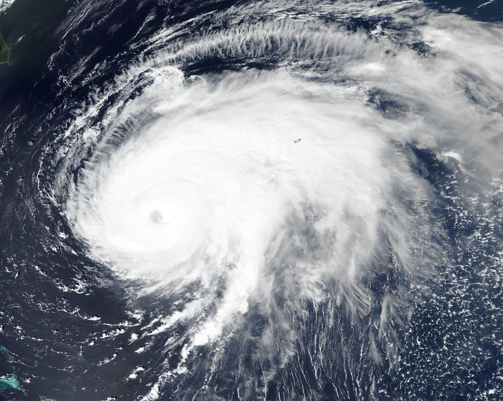 Hurricane Fiona photographed from space, a vast spiral of white cloud over the dark Atlantic on its track toward Atlantic Canada, September 2022